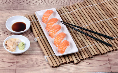 Japanese food - salmon sushi served with side dish.