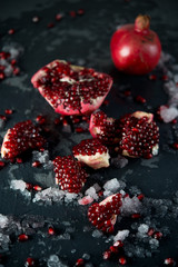 Fresh mature pomegranate on a black background
