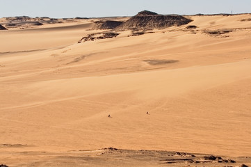 Two cyclists in the middle of the desert near Aswan, Egypt