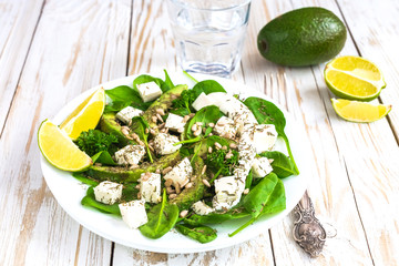 Salad with avocado, feta cheese, spinach, lime and spices
