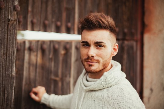 Attractive Guy Opening An Old Door