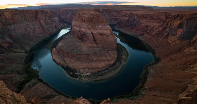 Horseshoe Bend, Page, Arizona, USA - the famous horseshoe-shaped meander of the Colorado River seen from the lookout area at sunset - Timelapse with pan right to left 