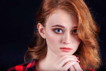 Portrait of beautiful girl. Freckled woman with wavy red hair an