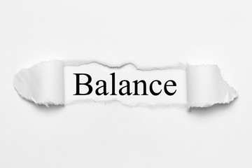 Balance on white torn paper