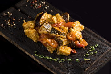 cooked vegetables, pepper, rosemary on a wooden board,
close-up