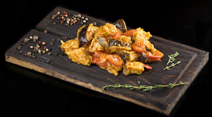 Vegetable stew , pepper, rosemary on a wooden board,