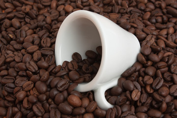 cup in a pile of coffee beans