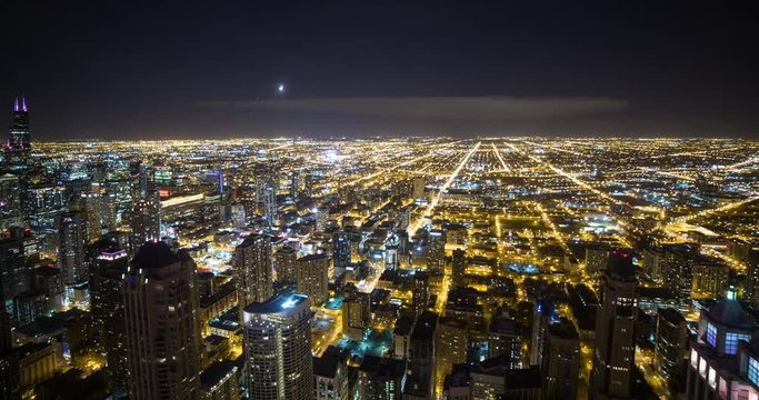 Chicago, Illinois, USA - view from observatory of John Hancock Center of illuminated City with Willis Tower (formerly Sears Tower) facing southwest at night - Timelapse with zoom out 