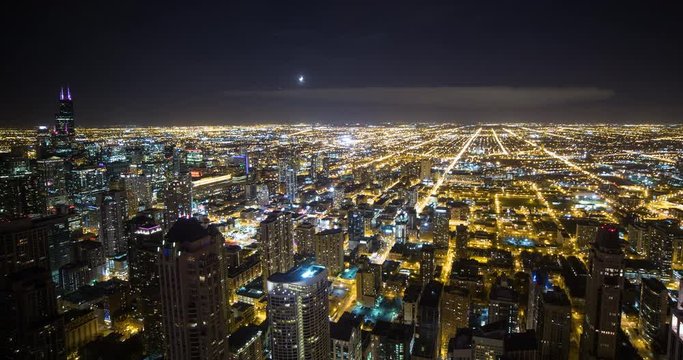 Chicago, Illinois, USA - view from observatory of John Hancock Center of illuminated City with Willis Tower (formerly Sears Tower) facing southwest at night - Timelapse with zoom in