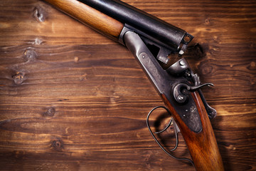 Shotgun on wooden background