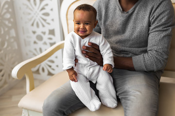 Father Playing With Baby Son At Home