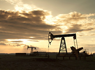 silhouette of oil rig at sunset the sun