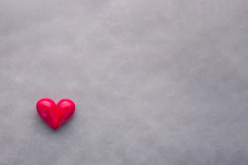 Fototapeta premium Red heart shape with bow on black (gray) background. Valentine's