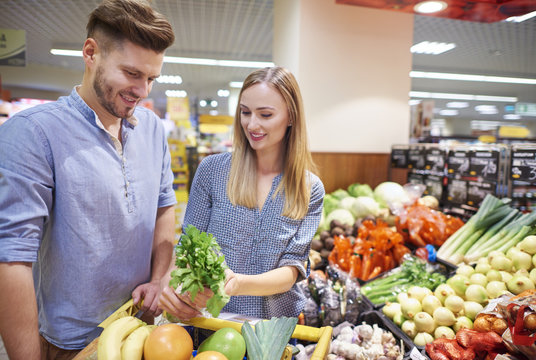 Couple choosing fresh food in supermarket