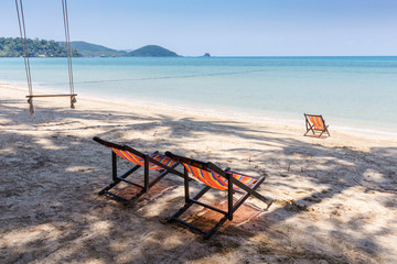 Beach chairs on tropical sand beach.
