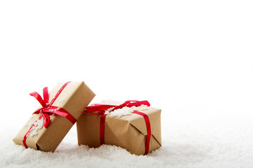 Christmas presents in brown paper with red ribbon