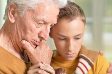Thoughtful grandfather and grandson