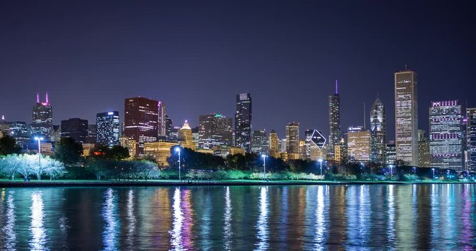 Chicago, Illinois, USA - view from the Lakefront Trail at the Field Museum / Shedd Aquarium facing north at shore of Lake Michigan and skyline at night - Timelapse with pan left right 