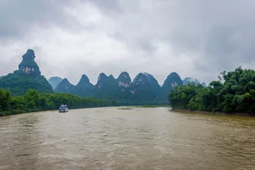 Fototapete Li River with misty clouds, China © dinozzaver