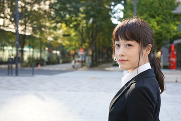 Business woman walking on the street with smile