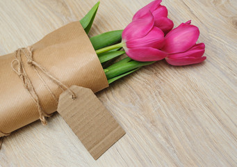 bouquet of red tulips in kraft paper