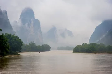 Foto op Canvas Li River with misty clouds, China © dinozzaver