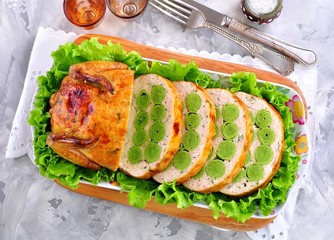Baked chicken stuffed with spinach pancakes, couscous and parsley.