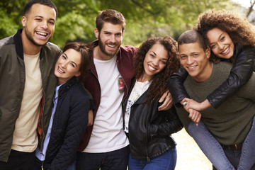 Six young adult friends on a country walk, looking to camera