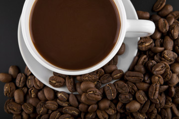cup with hot coffee and grains