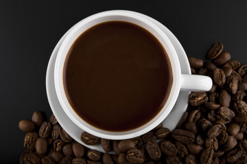 cup with hot coffee and grains