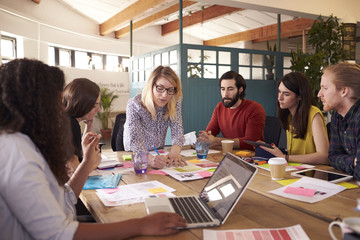 Female Manager Leads Brainstorming Meeting In Design Office