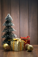 Fototapeta na wymiar Christmas gift box and decorations on wood desk
