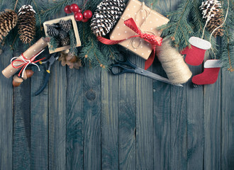 Christmas background. Packed gifts and scrolls, spruce branches
