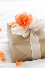 Beautiful colorful pretty gift or present in a golden paper with