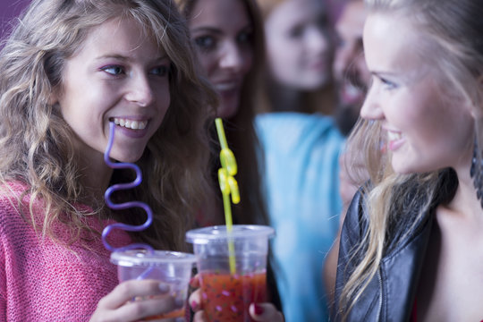 Women drinking cocktails at nightclub