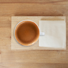 a cup of espresso on wooden background.