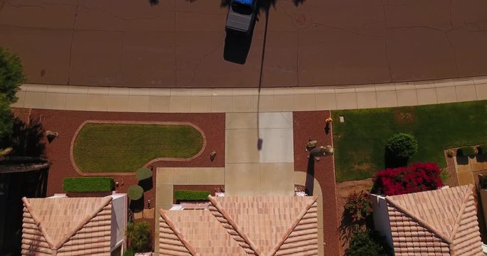 A unique aerial view of a truck backing into a typical Arizona neighborhood residence. Phoenix suburb.  	