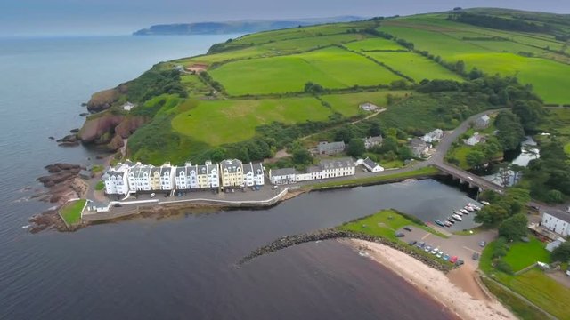 The Big Green Fields On The Small Village In Cushendun An Apartment House Near The Sea And The Long Road Going Up To The Mountain In Ireland