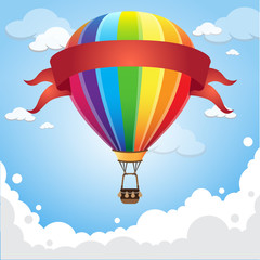 Obraz premium Hot air balloon in the sky with red banner ribbon cloud background