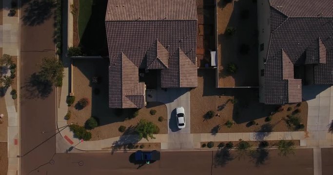 A unique aerial view of a car pulling out of a typical Arizona neighborhood residence. Phoenix suburb.  	