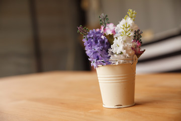 Coffee shop with dry flowers in vase.