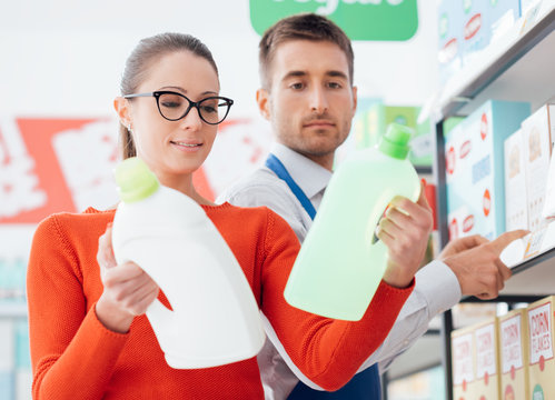 Supermarket Clerk Helping A Customer