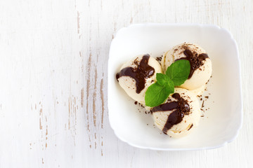 Ice cream with chocolate topping and mint. Top view with copy sp