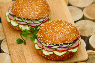 Fast food. Hot sandwiches on wooden plank