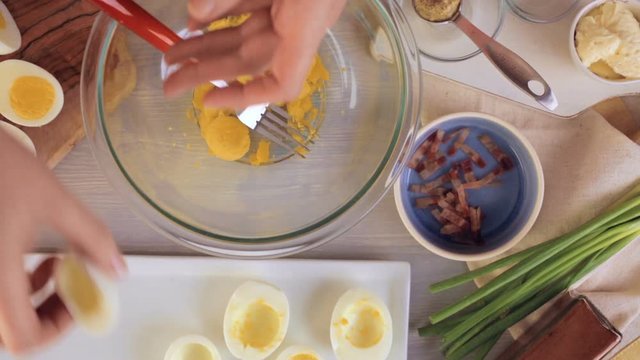 Preparing deviled eggs with organic eggs for appetizer. Step by step recipe