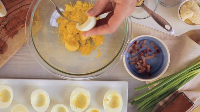 Preparing deviled eggs with organic eggs for appetizer. Step by step recipe
