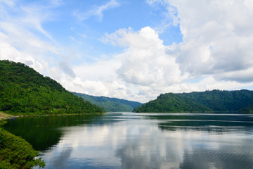 View of river from greenery mountain with blue sky