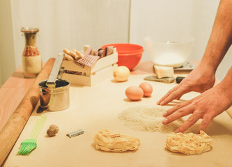 Young man making fresh pasta at home - Chef wood table with all