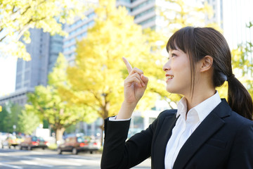 Young business woman pointing something with smile