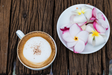 Coffee cup placed on a piece of old wood